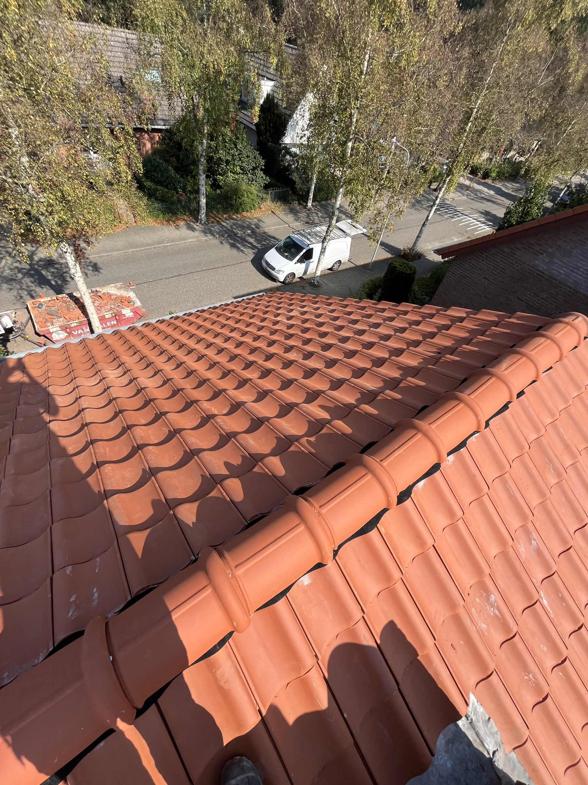 Prachtig resultaat van een nieuw gelegd pannendak met rode dakpannen in een Haagse woonwijk.